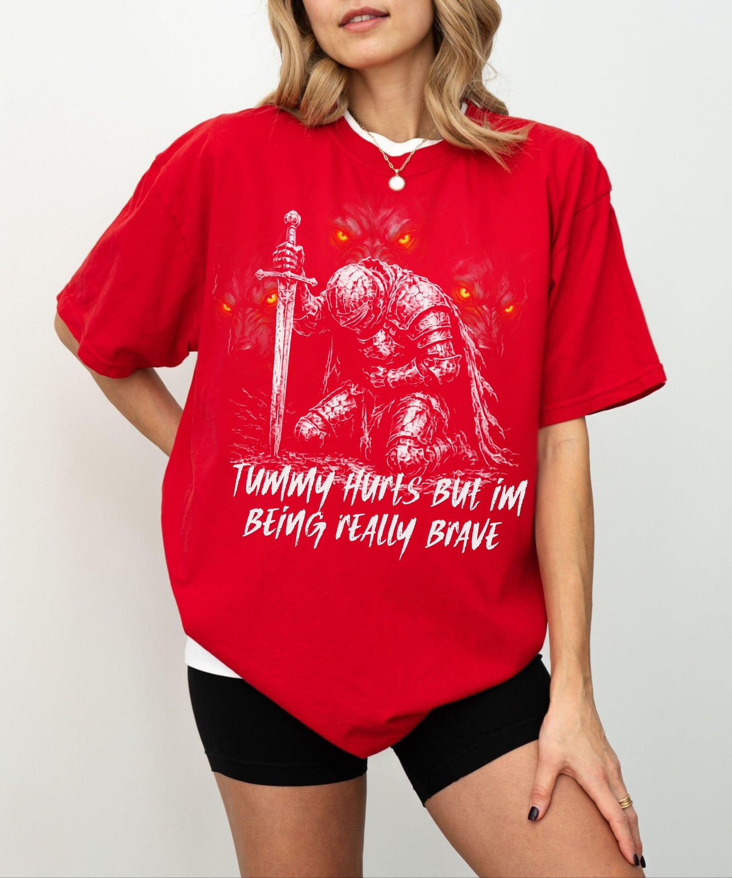 Funny knight graphic tee with Serverus and "Tummy Hurts But I'm Being Really Brave" text — Red color mockup showing relaxed fit
