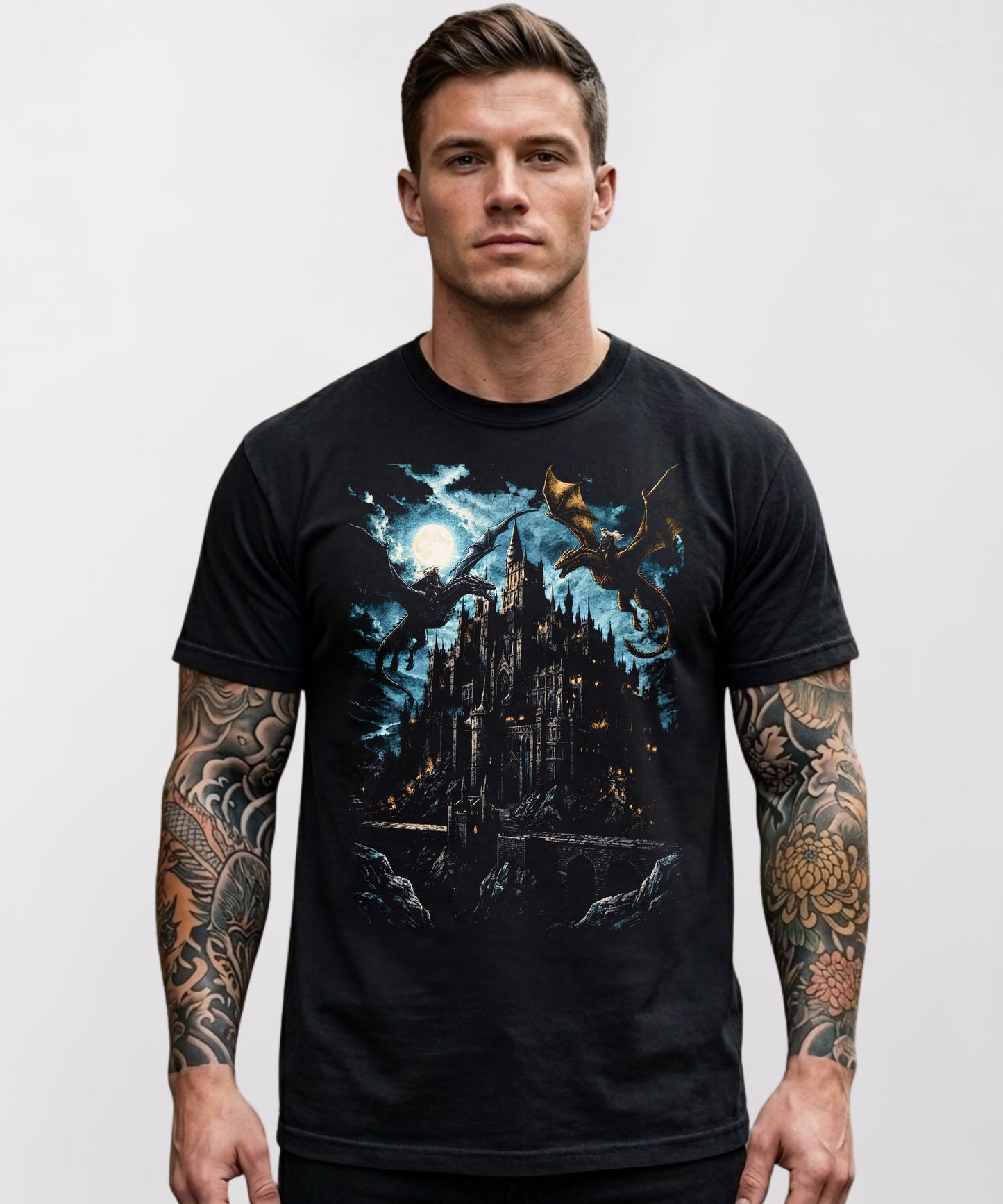 Model wearing a black heavyweight graphic t-shirt with a dark fantasy gothic castle and dragon design on the chest, styled casually.