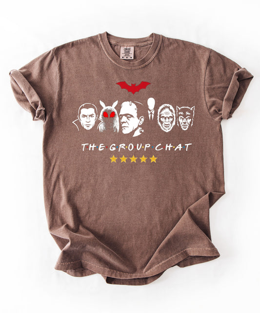 Espresso garment-dyed unisex t-shirt featuring The Group Chat horror monster squad graphic โ Dracula, Mothman with red eyes, Frankenstein, Slender Man, Bigfoot, and Werewolf faces with red bat above and five gold stars below