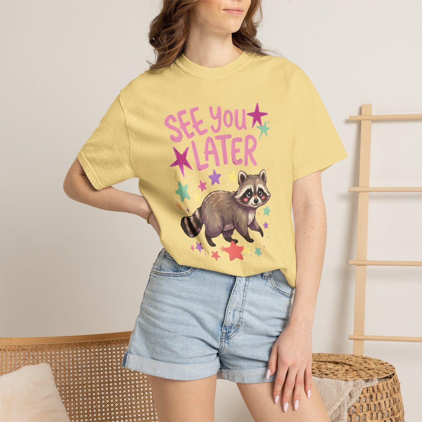 butter t-shirt with raccoon graphic and 'See You Later' text on the front with cute raccoon and cute raccoon on back of shirt on a white background