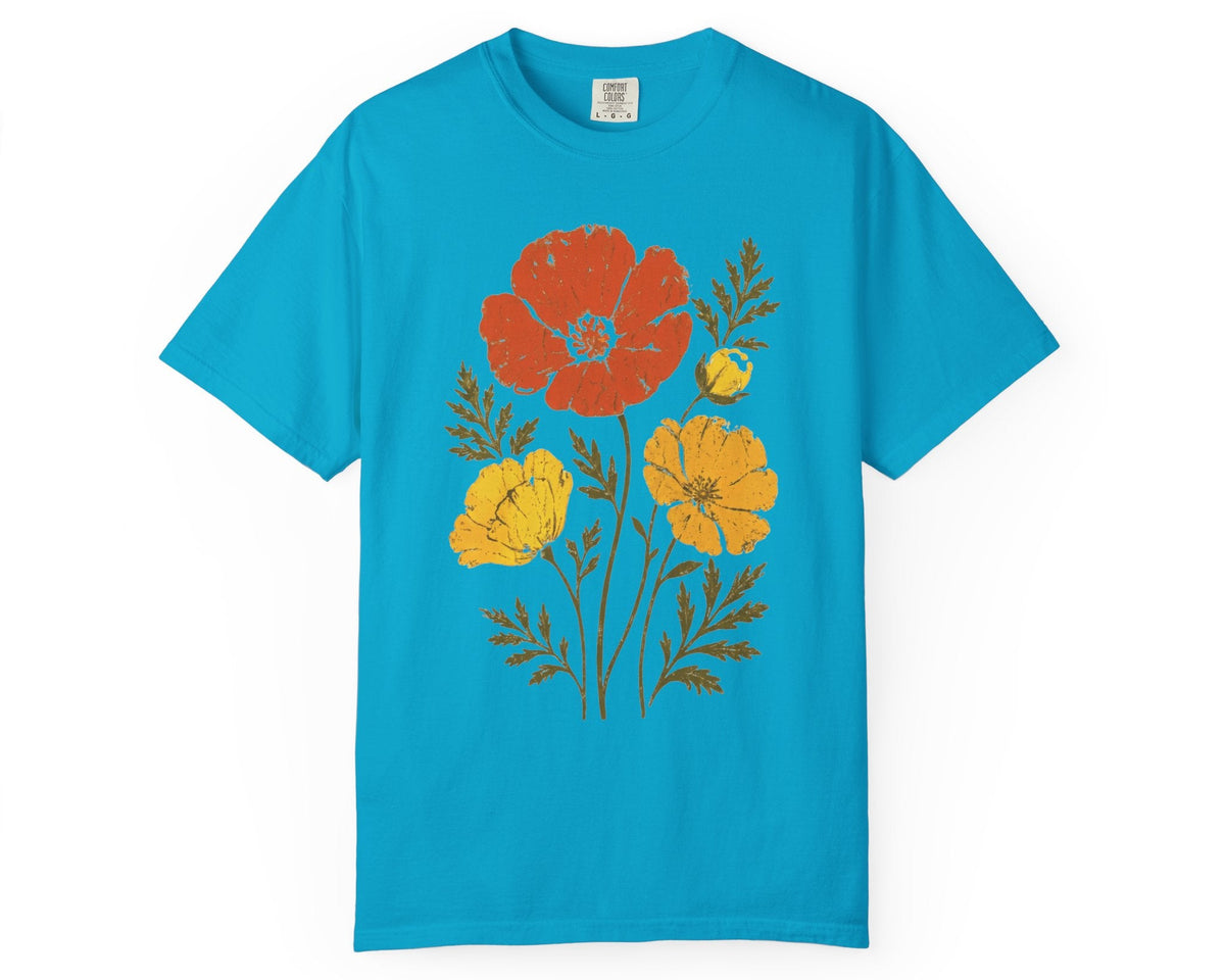 A Sapphire blue short-sleeve t-shirt with a graphic print of red, yellow, and orange flowers with brown stems, displayed flat against a solid white background.