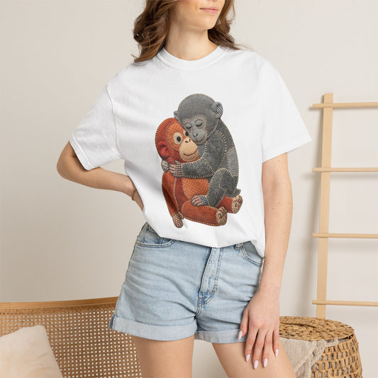 Person wearing a white t-shirt with monkey design and denim shorts on a neutral background