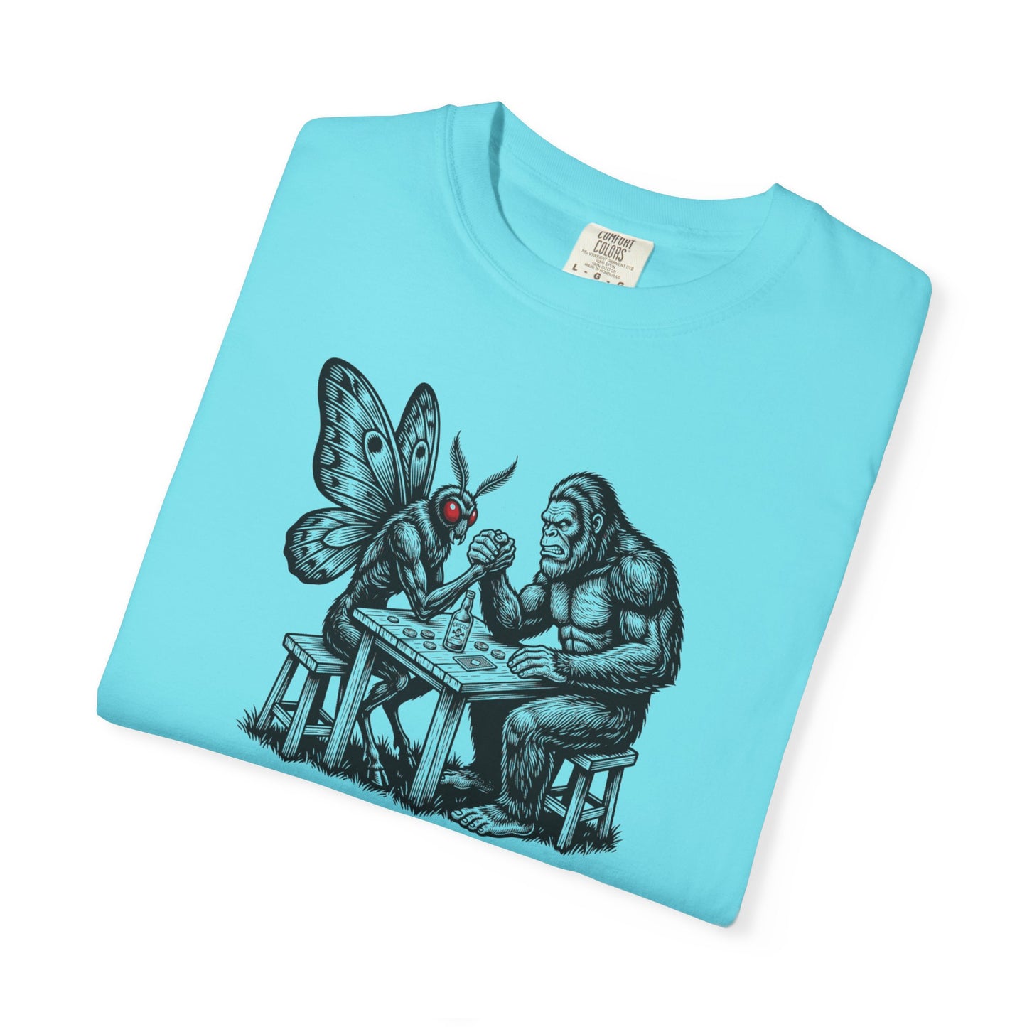 Lagoon Blue garment-dyed unisex Bigfoot vs Mothman arm wrestling graphic tee — funny cryptid shirt