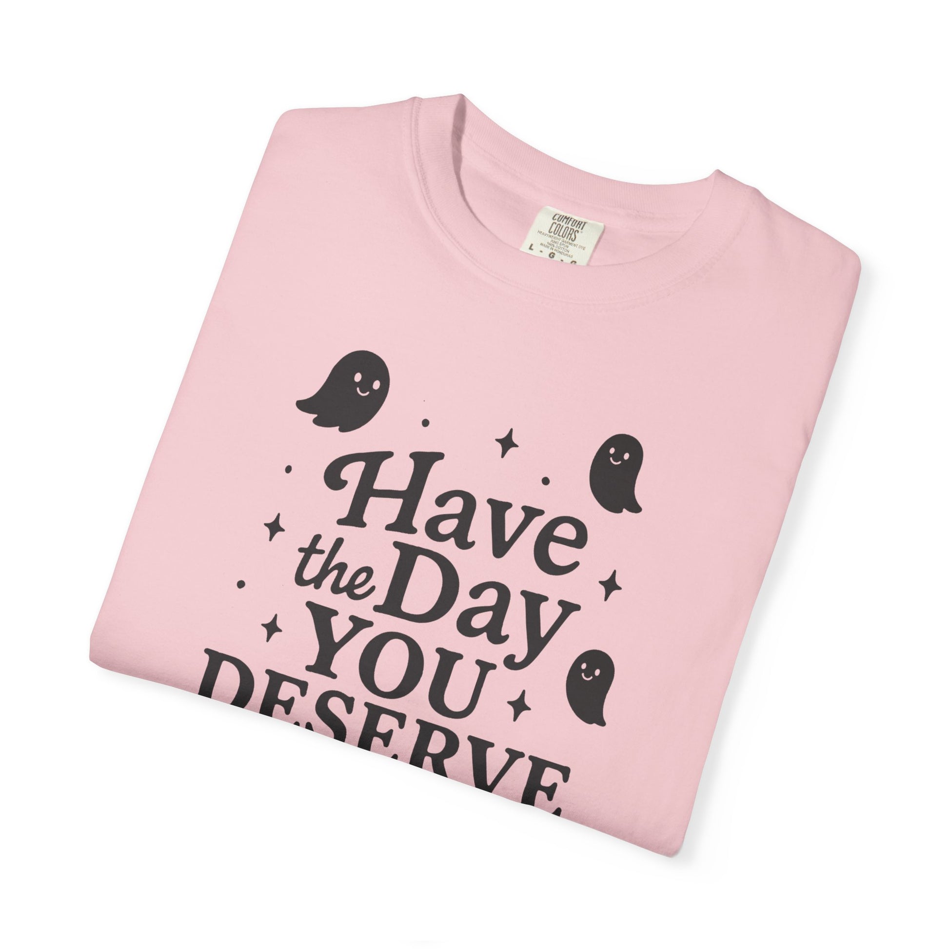 light pink  t-shirt with Halloween-themed design and text that says "have the day you deserve" on a white background