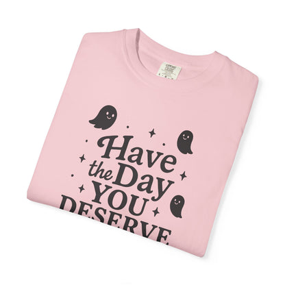 light pink  t-shirt with Halloween-themed design and text that says "have the day you deserve" on a white background