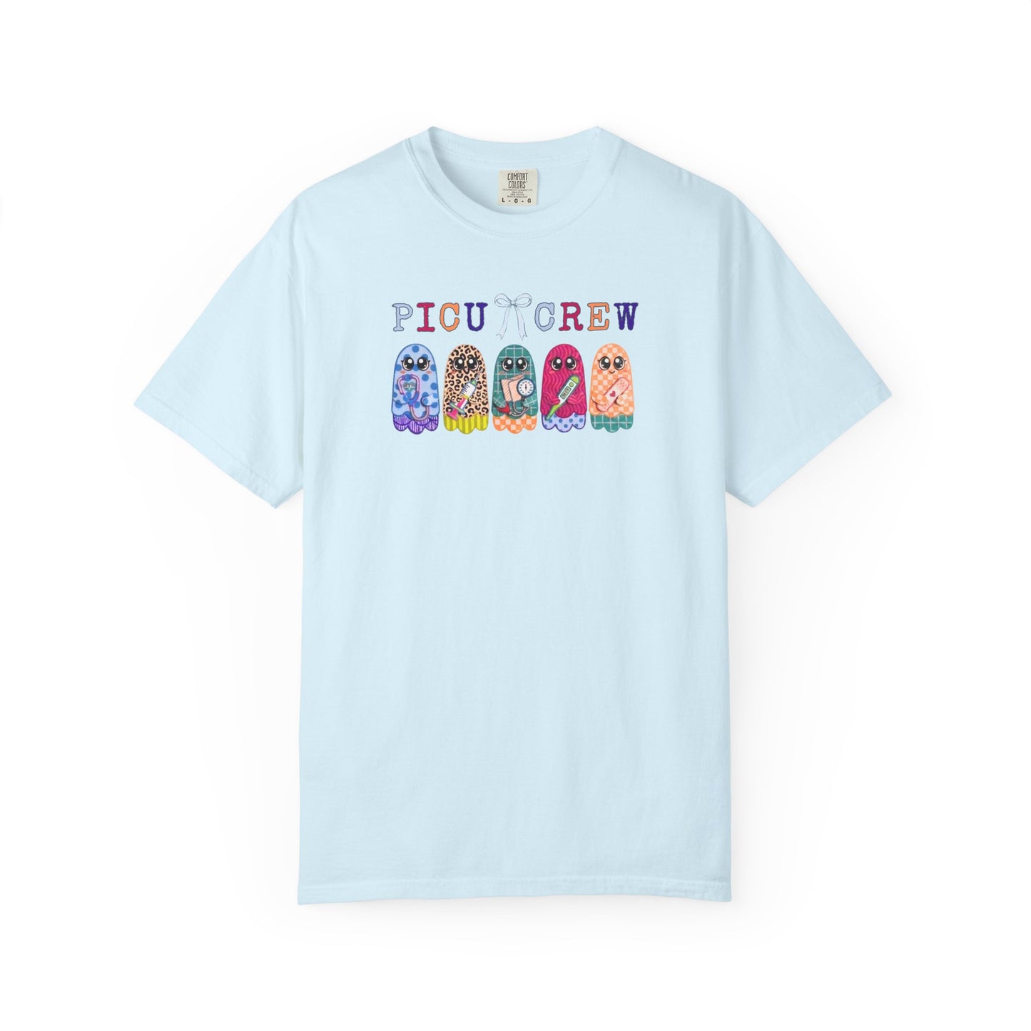 Chambray Comfort Colors PICU Crew t-shirt with five colorful patterned ghosts holding nursing tools — pediatric ICU nurse graphic tee, flat lay