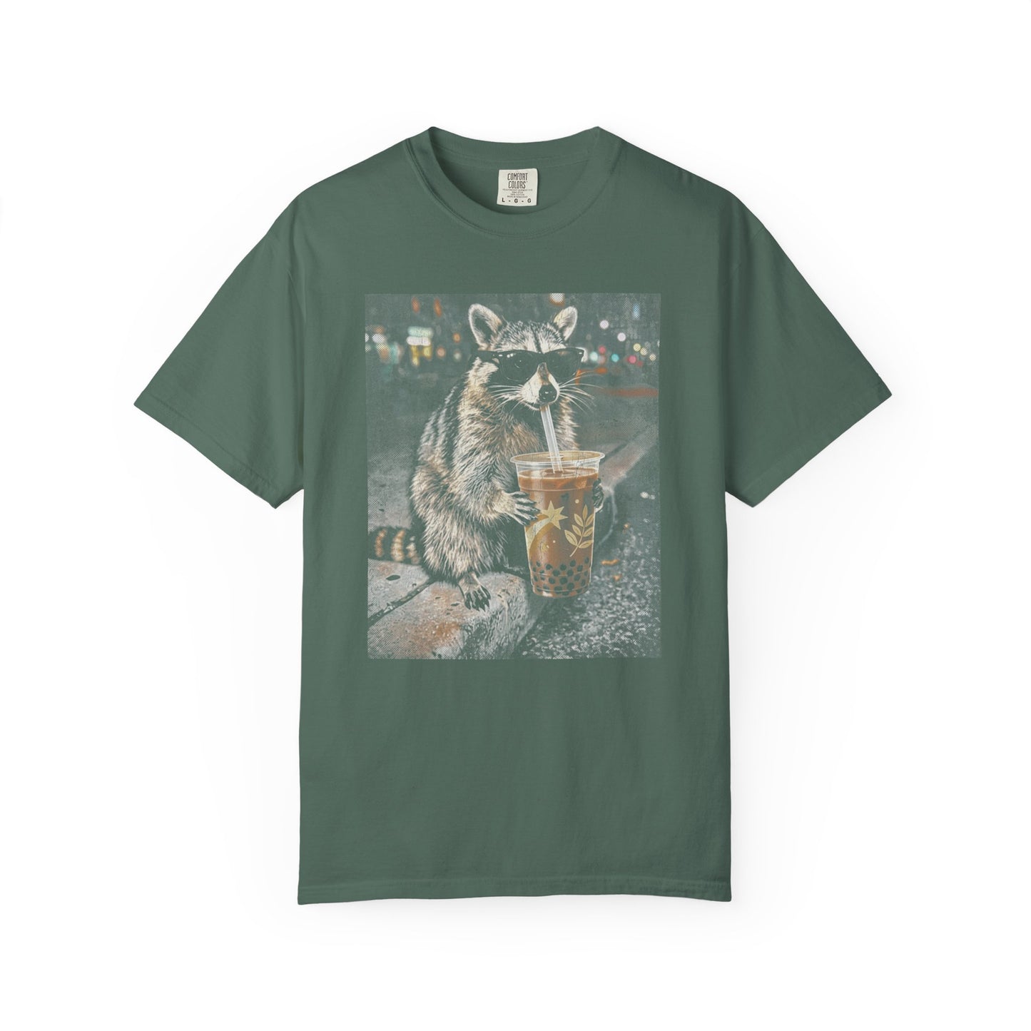 moss t-shirt with a raccoon graphic drinking from a cup on a white background