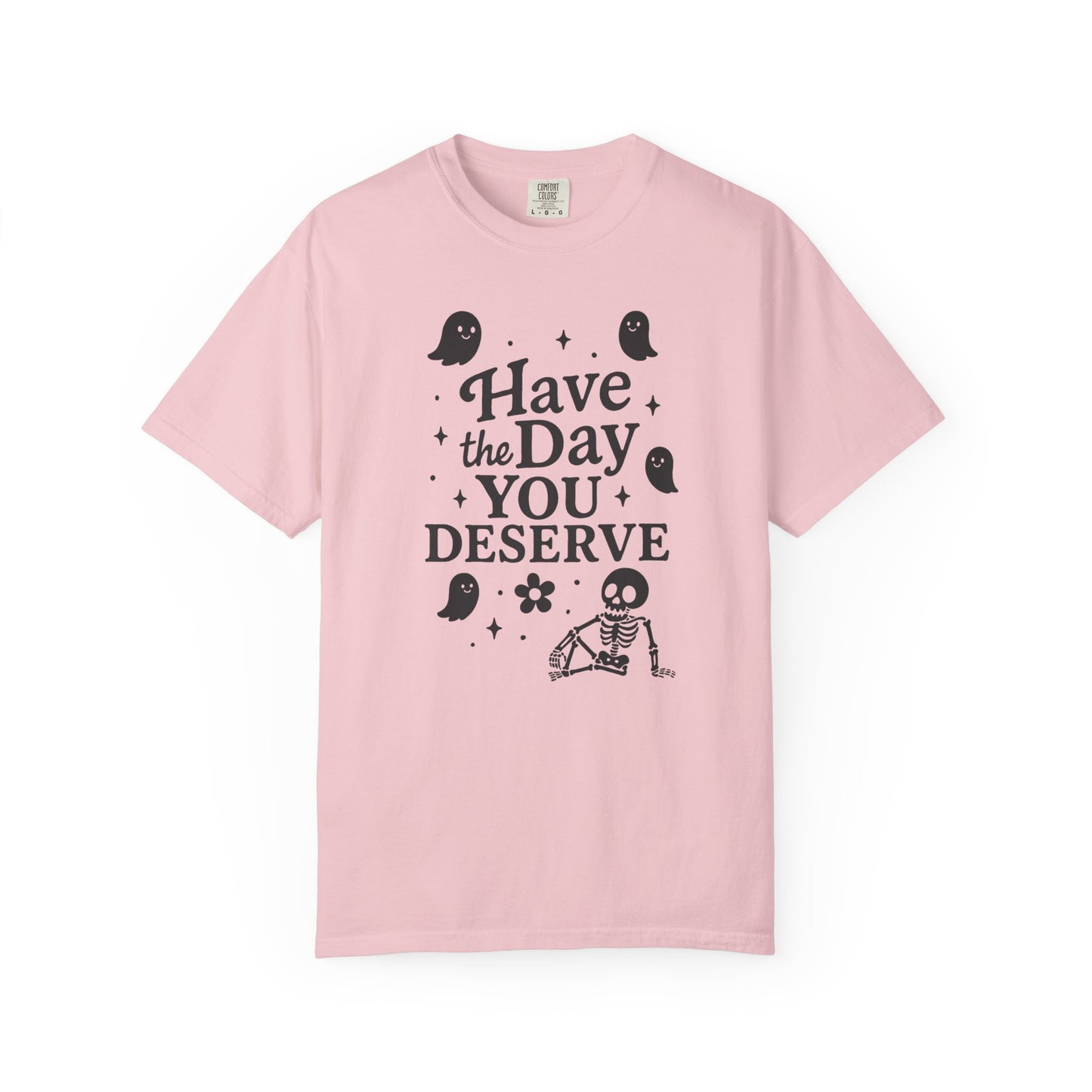 light pink t-shirt with Halloween-themed design and text that says "have the day you deserve" on a white background