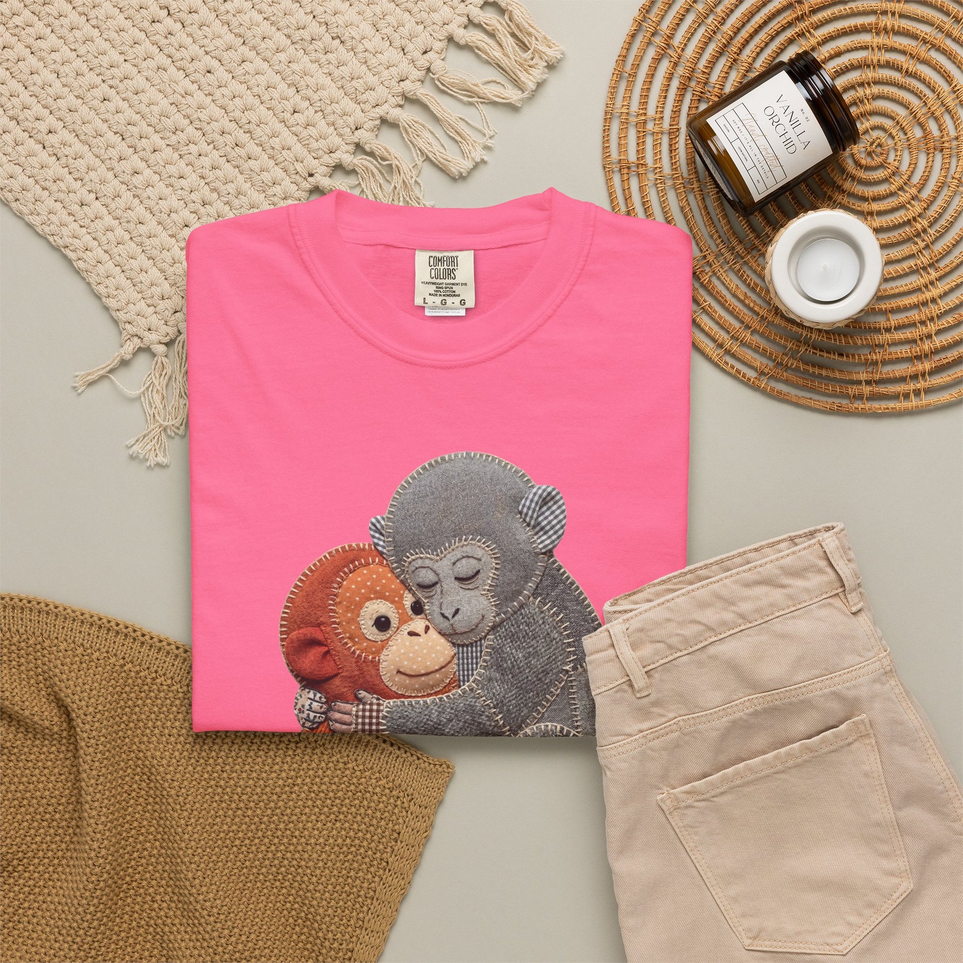 watermelon t-shirt with monkey design on a neutral surface with accessories.