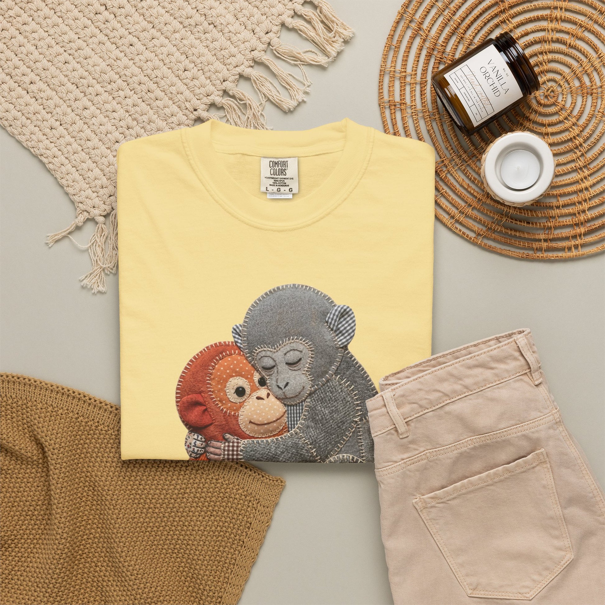 butter t-shirt with monkey design on a neutral surface with accessories