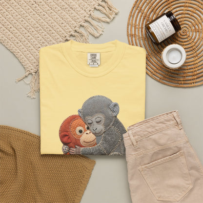 butter t-shirt with monkey design on a neutral surface with accessories