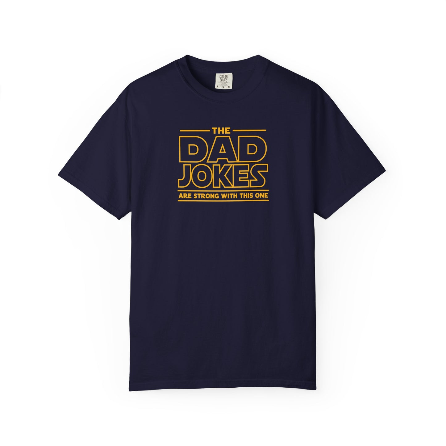 a true navy t-shirt with yellow text 'The Dad Jokes Are Strong With This One' in front of a blurred background.