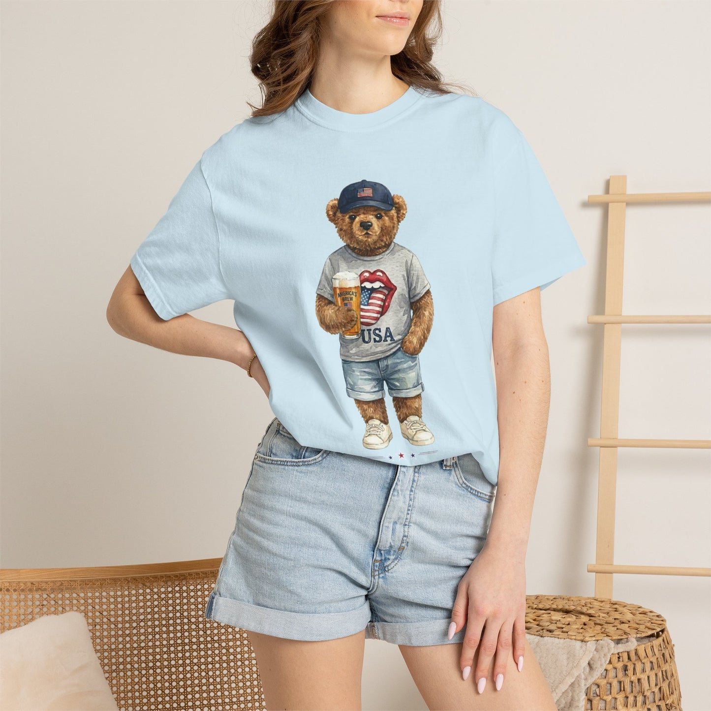 Person wearing a chambray t-shirt with a bear graphic, standing against a neutral background.