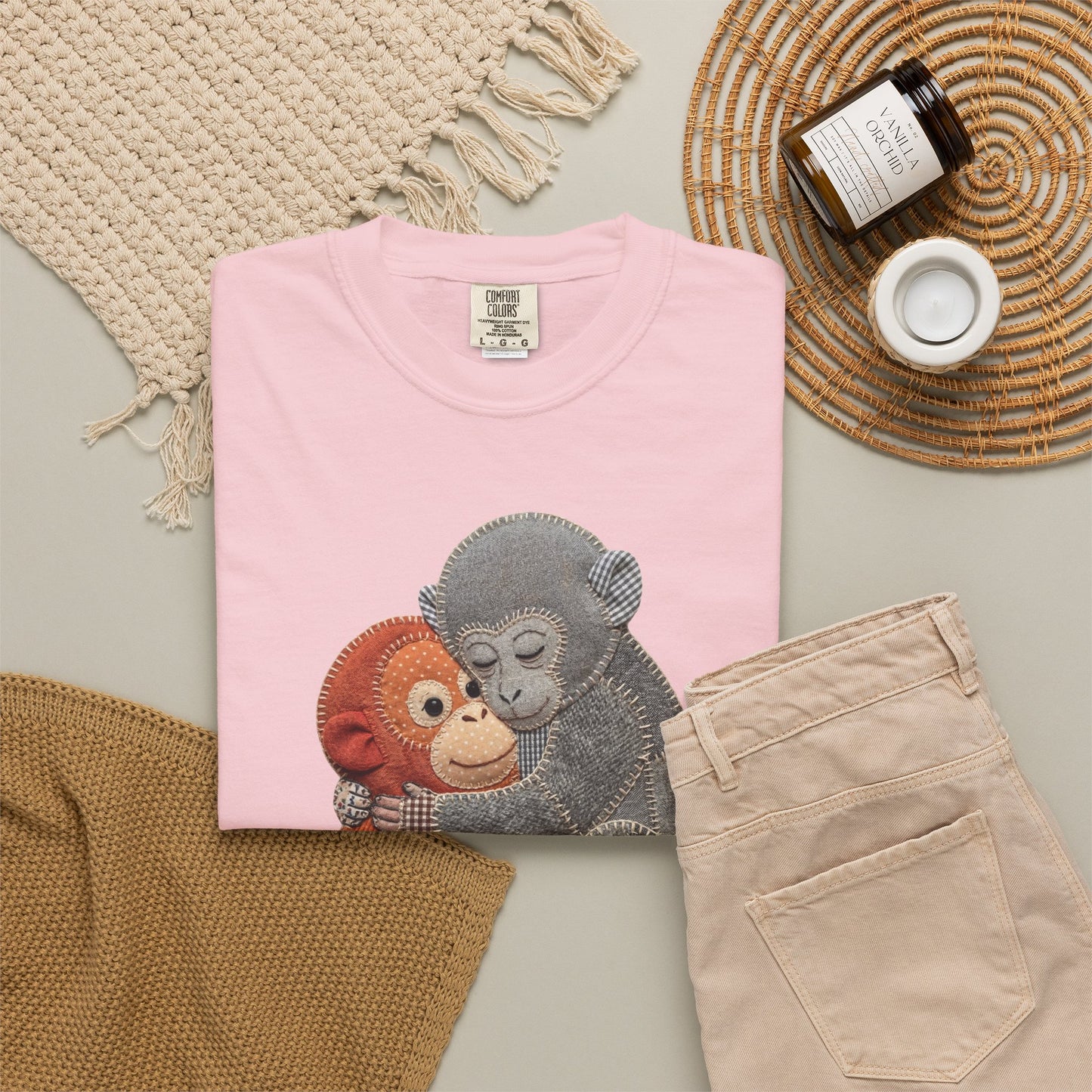 blossom t-shirt with monkey design on a neutral surface with accessories