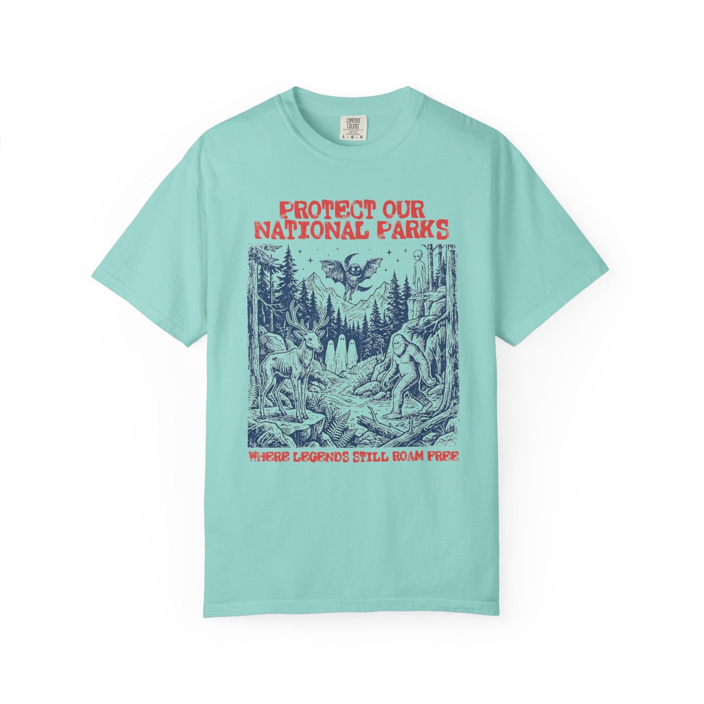 Comfort Colors® Protect Our National Parks cryptid graphic tee in Chalky Mint — Bigfoot, Mothman, aliens, ghosts wilderness scene, flat lay