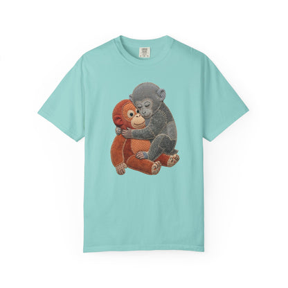Light blue t-shirt with a graphic of two monkeys hugging on a white background