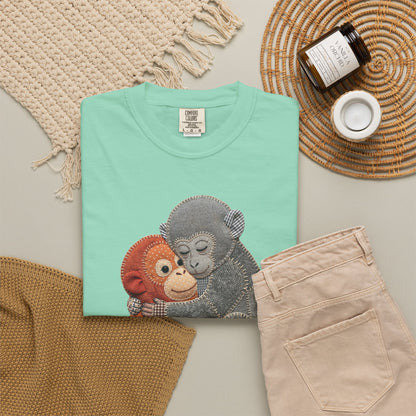 Folded island reef t-shirt with monkey design on a neutral surface with accessories.