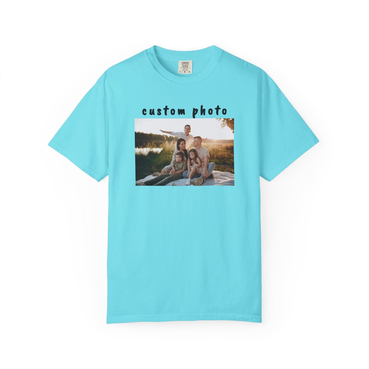 Lagoon blue t-shirt with a printed photo of a family by a lake on a white background