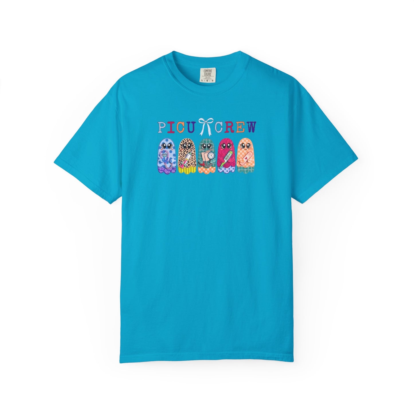 Sapphire Comfort Colors PICU Crew t-shirt with five colorful patterned ghosts holding nursing tools — pediatric ICU nurse graphic tee, flat lay