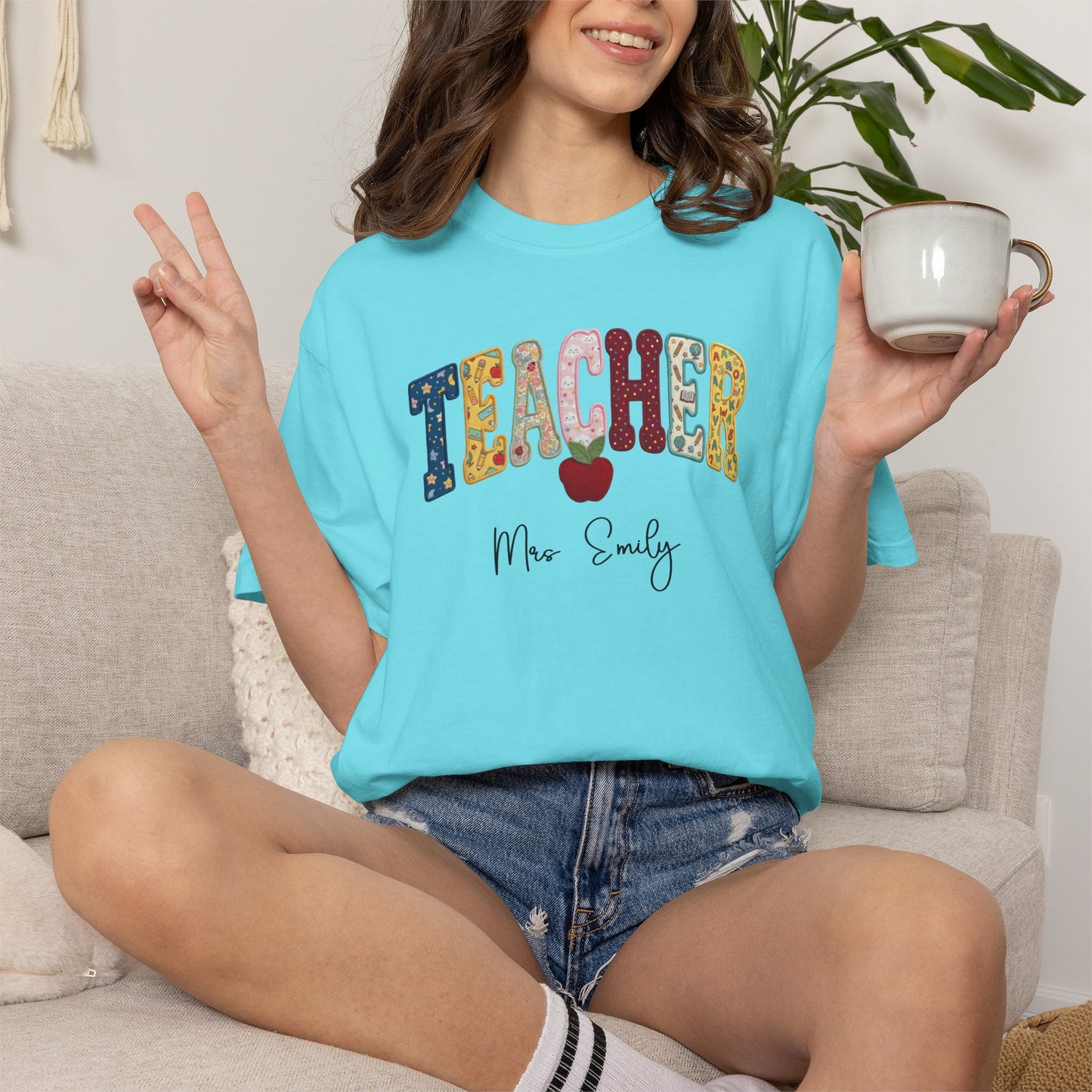 Personalized teacher shirt in Lagoon blue with faux patchwork TEACHER lettering, red apple graphic, and custom name — garment-dyed heavyweight tee