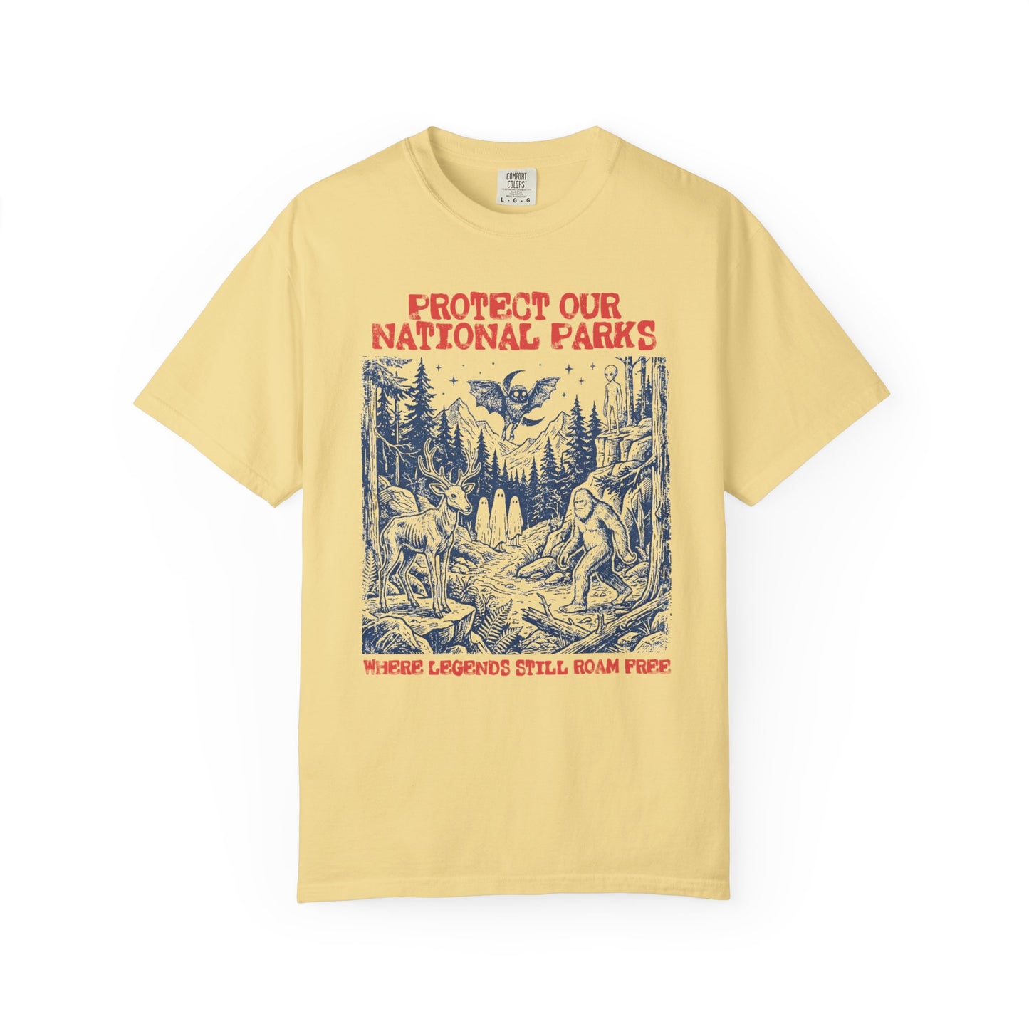 Comfort Colors® Protect Our National Parks cryptid graphic tee in Butter — Bigfoot, Mothman, aliens, ghosts wilderness scene, flat lay