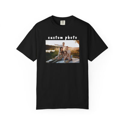 Black t-shirt with a printed photo of a family by a lake on a white background