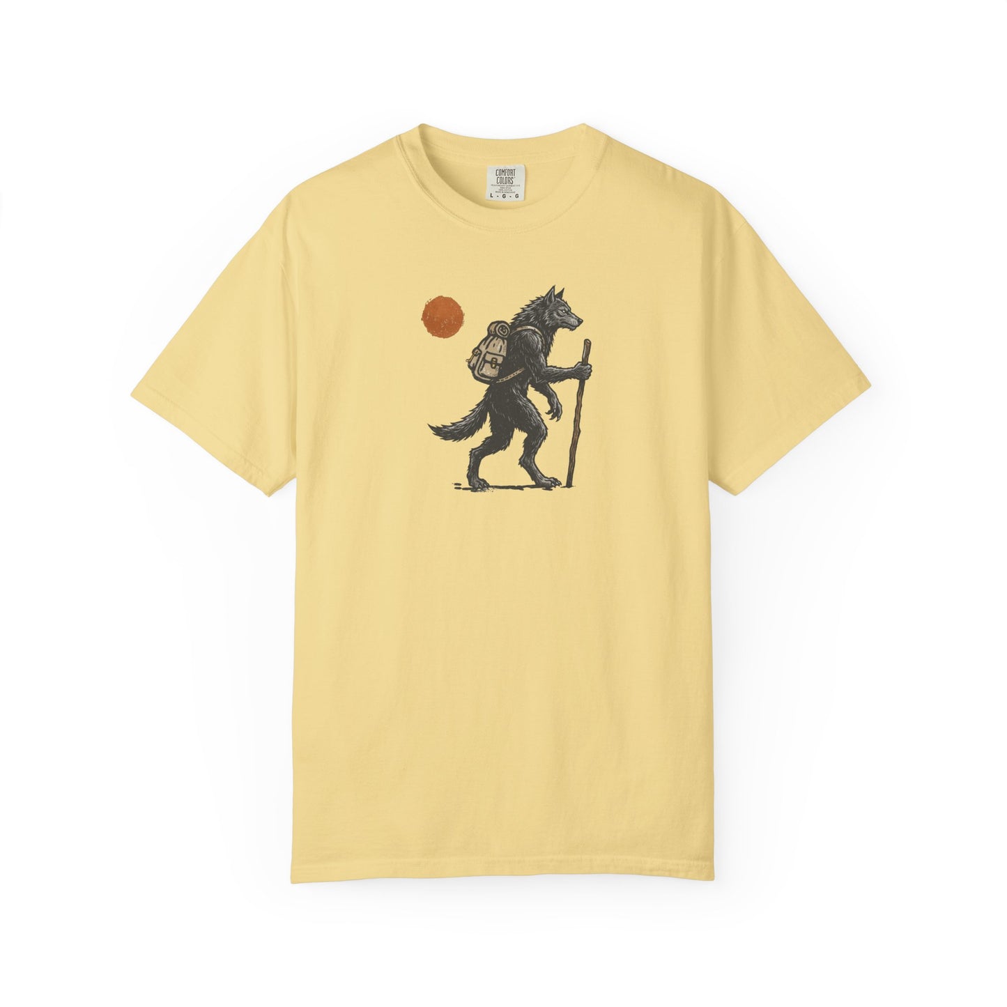 Hiking Wolf graphic t-shirt in Butter — werewolf with backpack and walking stick print on garment-dyed heavyweight cotton tee.