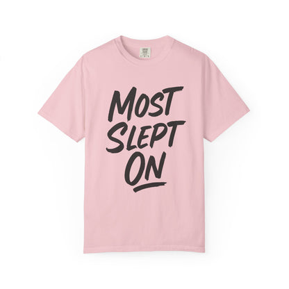 Pink t-shirt with black text 'MOST SLEPT ON' on a white background