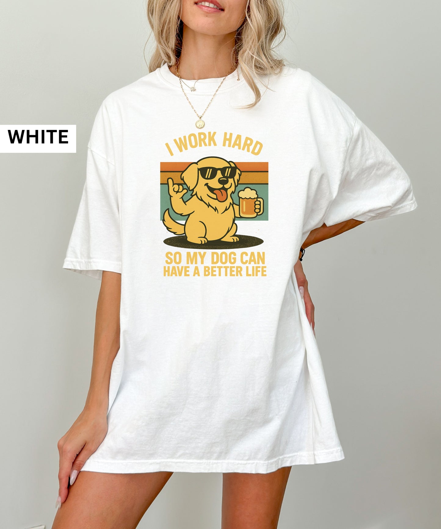 Person wearing a white t-shirt with a graphic of a dog and text that says "i work hard so my dog can have a better life, set indoors.