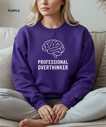 Person wearing a purple sweatshirt with a brain graphic and 'Professional Overthinker' text, sitting on a couch.

