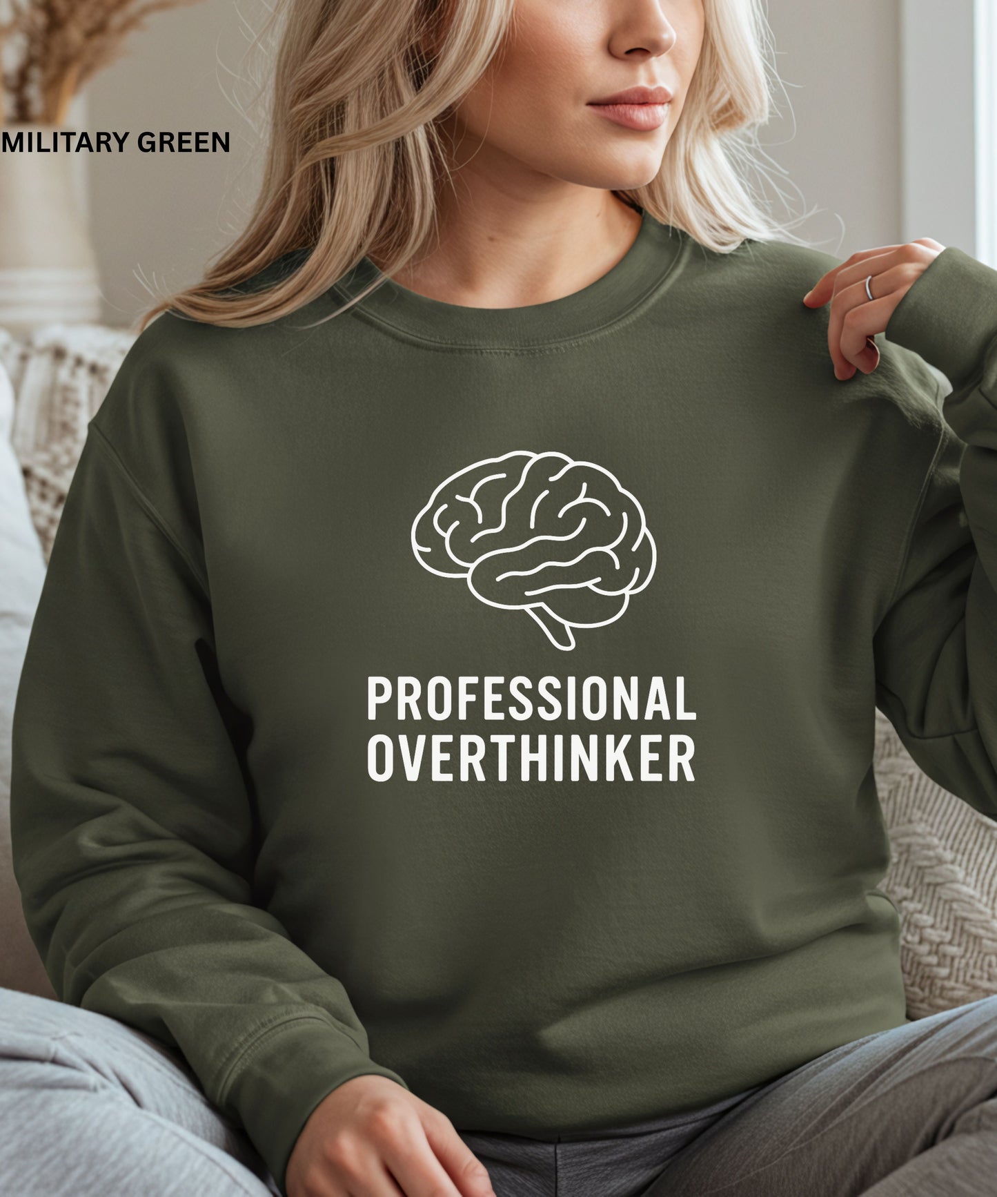 Person wearing a military green sweatshirt with a brain graphic and text 'Professional Overthinker'.