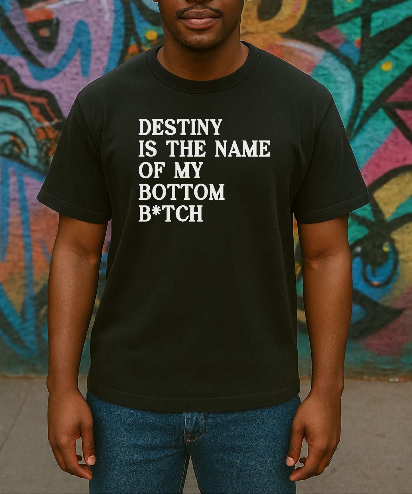Person wearing a black t-shirt with text 'Destiny is the name of my bottom B*tch' on a plain background.