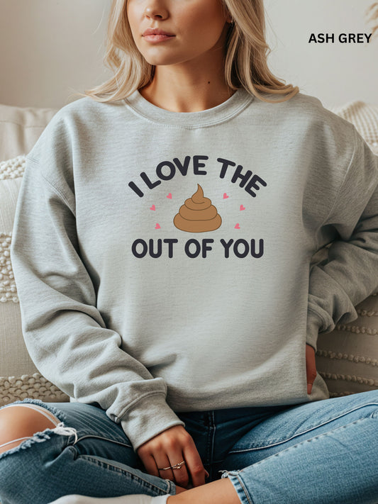 Person wearing an ash gray sweatshirt with a humorous design that says"i love the shit out of you", sitting on a couch.