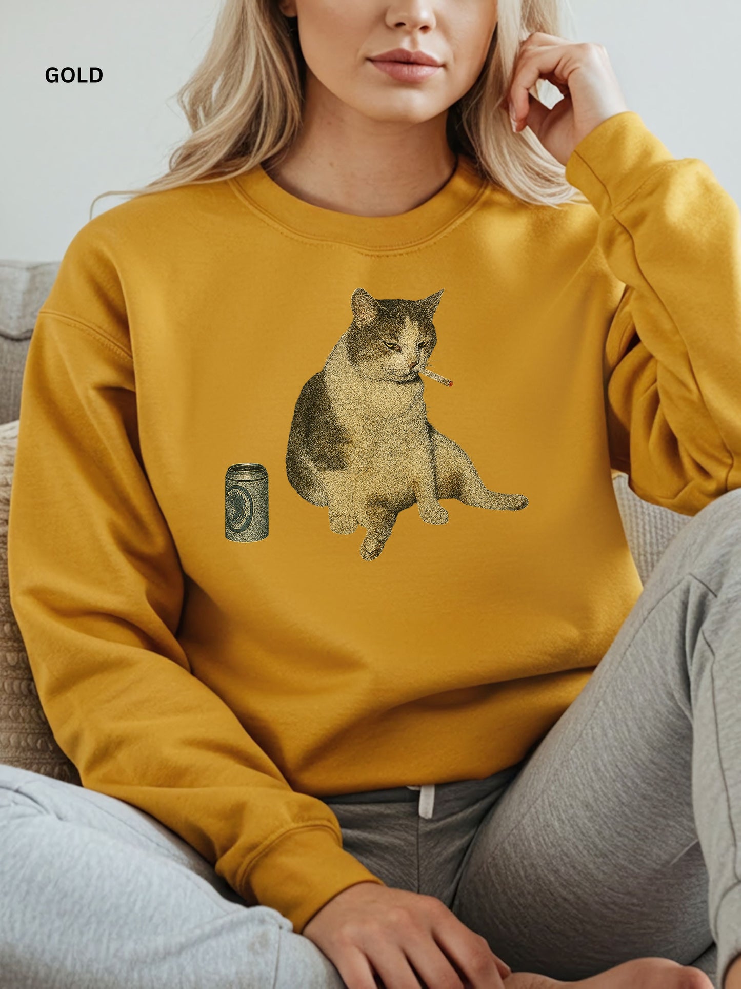 Person wearing a gold yellow sweatshirt with a cat and beer graphic.