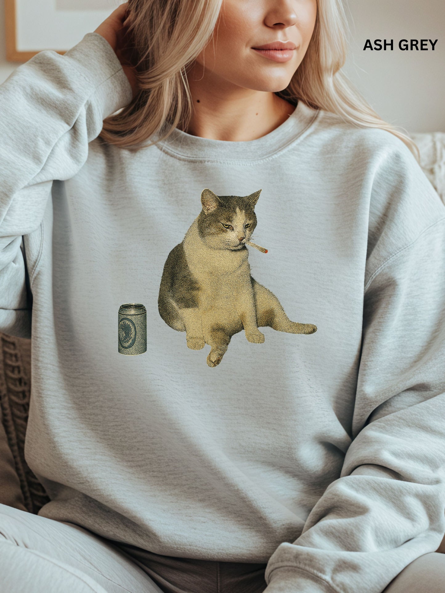 Person wearing an ash gray sweatshirt with a cat smoking a cigarette graphic.
