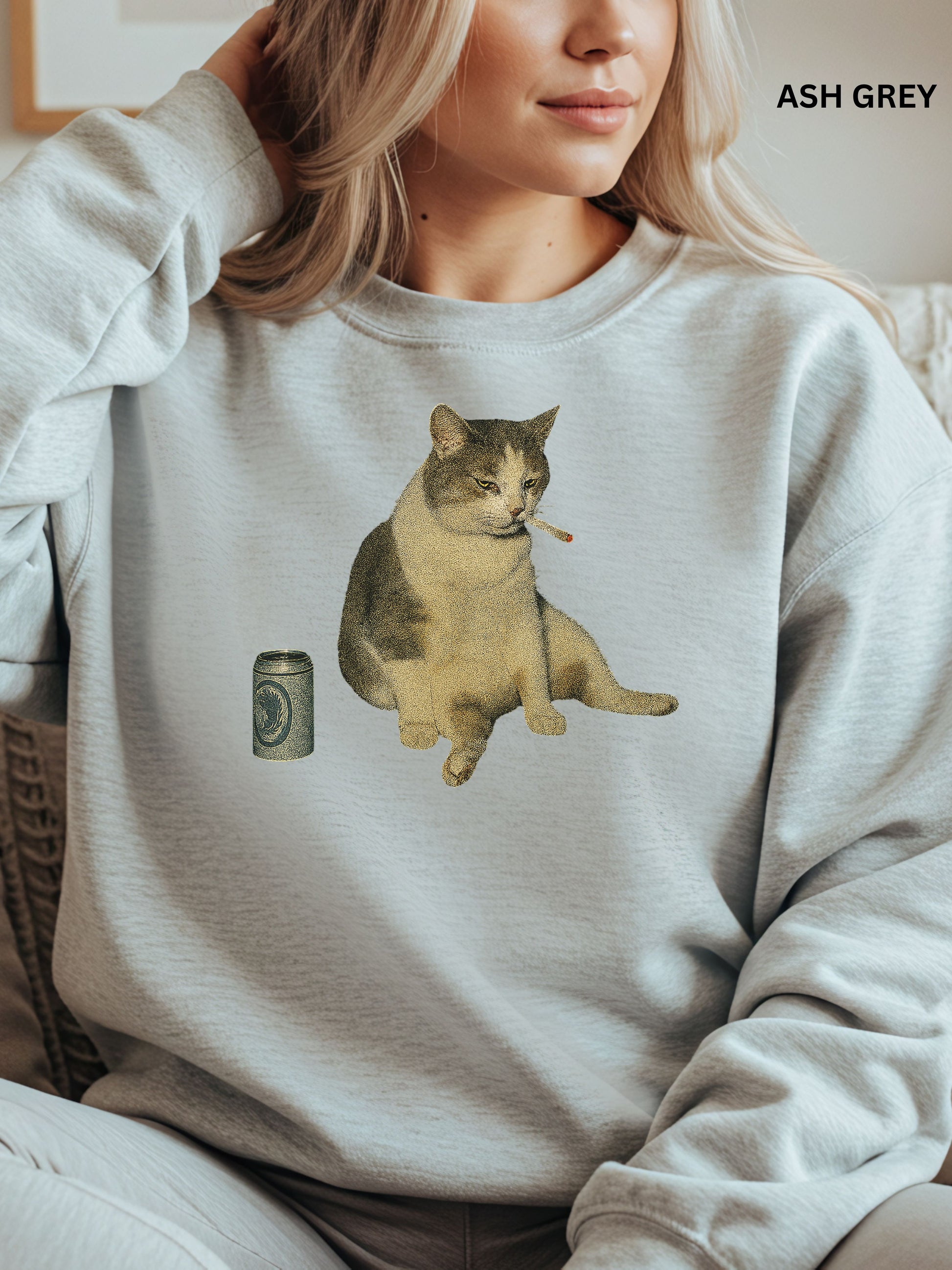 Person wearing an ash gray sweatshirt with a cat smoking a cigarette graphic.