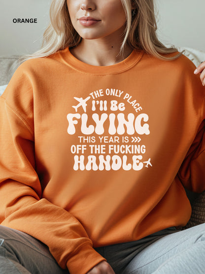 Person wearing an orange sweatshirt with a humorous text design that says "the only place ill be flying is off the fucking handle, sitting on a couch.