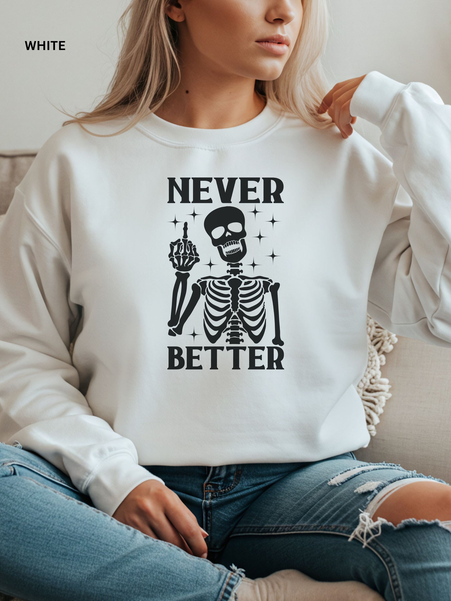 Person wearing a white sweatshirt with a skeleton graphic and text that says "never better"