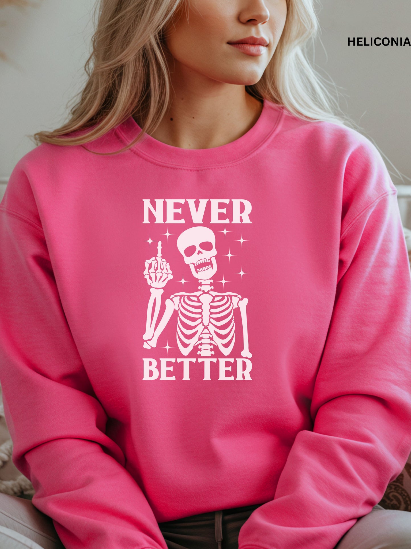 Person wearing a heliconia sweatshirt with a skeleton graphic and text that says "never better"
