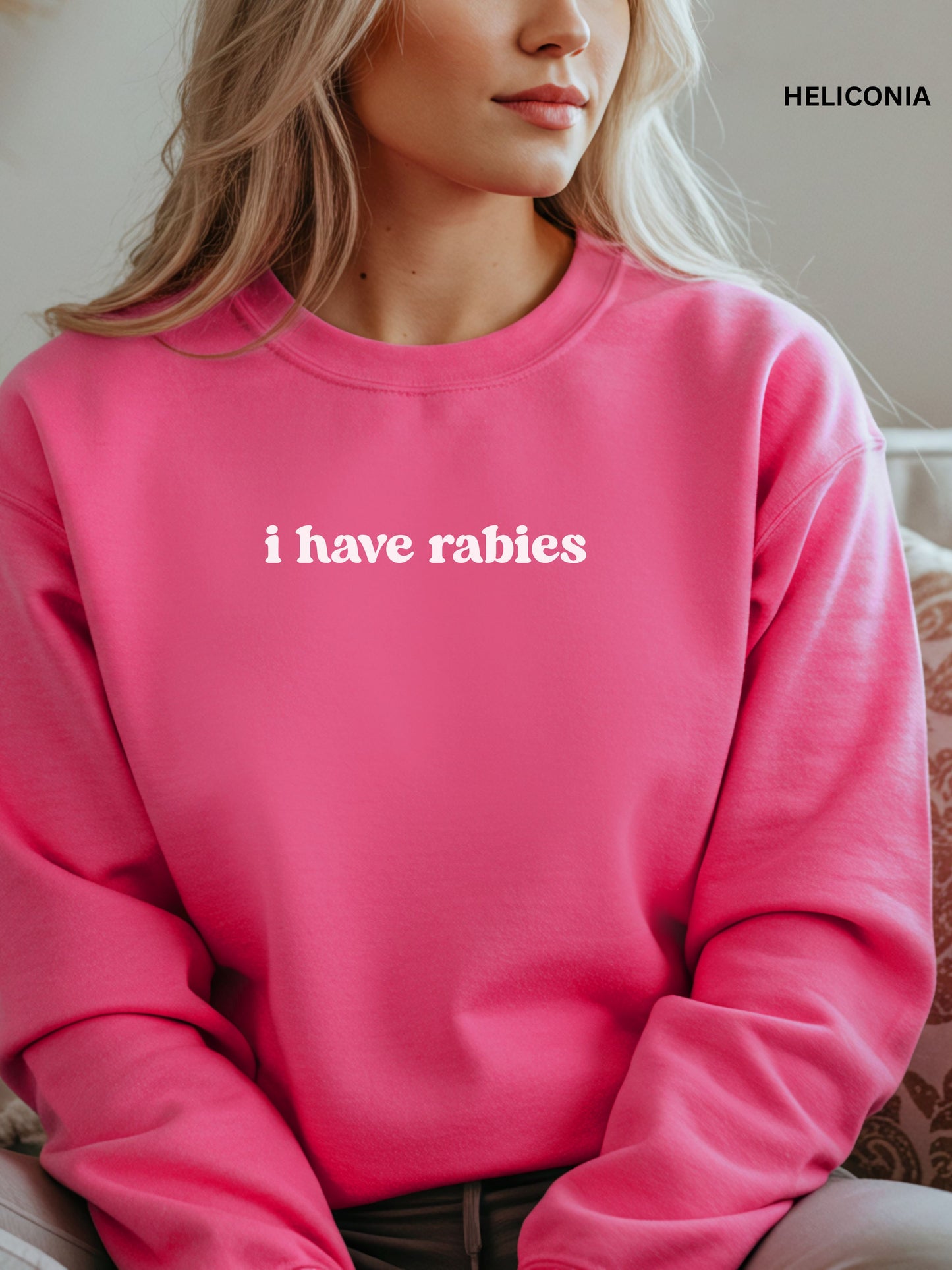 Person wearing a heliconia sweatshirt with 'i have rabies' text, brand 'Heliconia' visible.