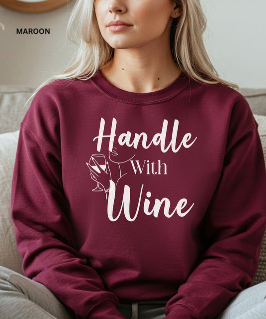 Maroon sweatshirt with 'Handle With Wine' text and graphic, worn by a person.