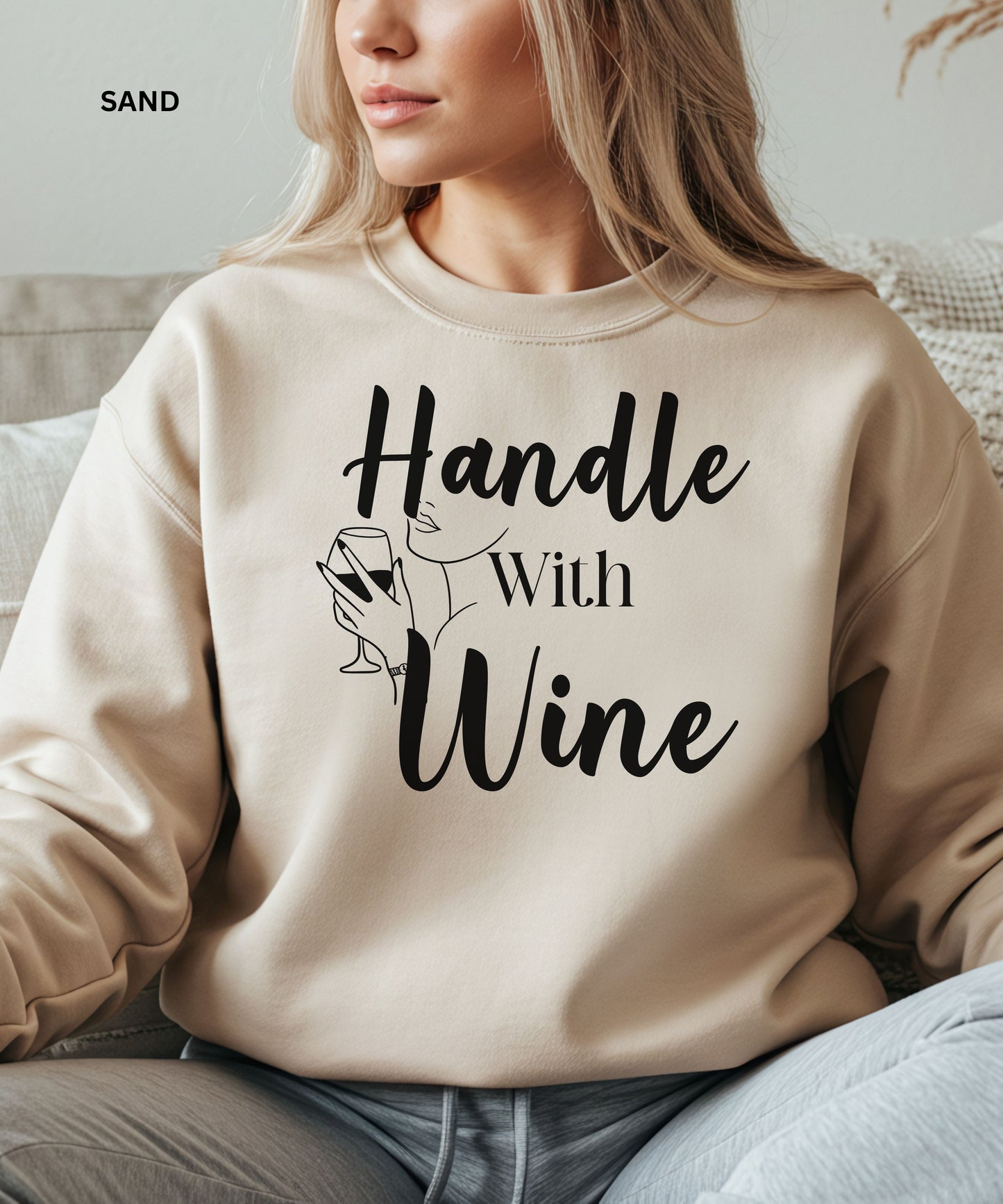 sand sweatshirt with 'Handle With Wine' text and wine glass graphic worn by a person.