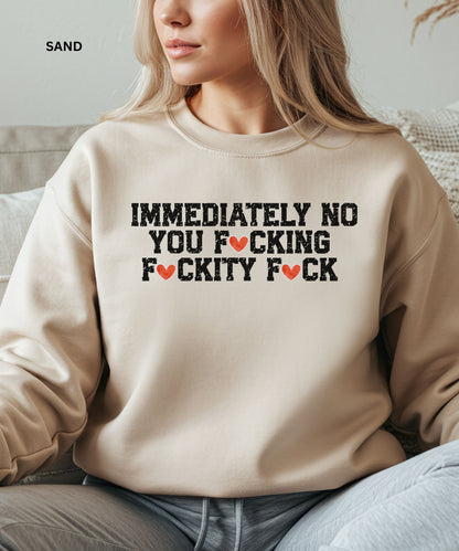 Person wearing a beige sweatshirt with a graphic design.