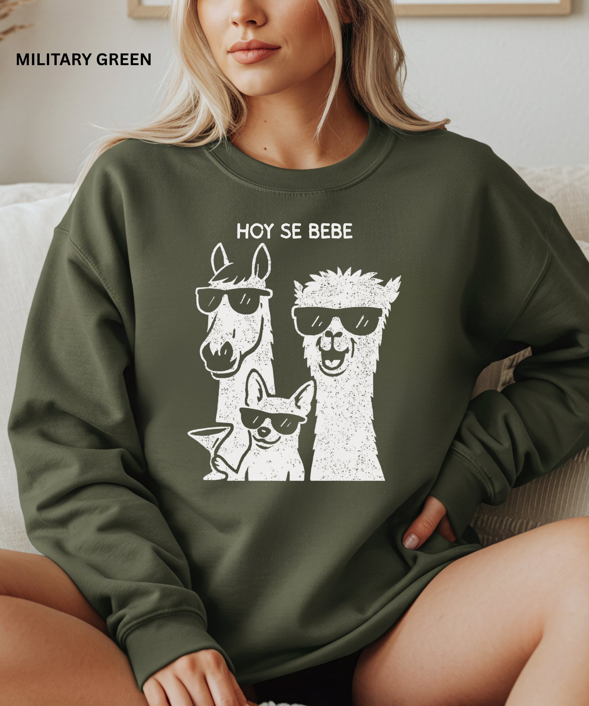 Person wearing a green sweatshirt with llama graphic and text