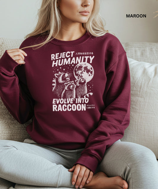 Person wearing a maroon colored sweatshirt with a graphic design that says "reject humanity evolve into racoon" sitting on a couch.