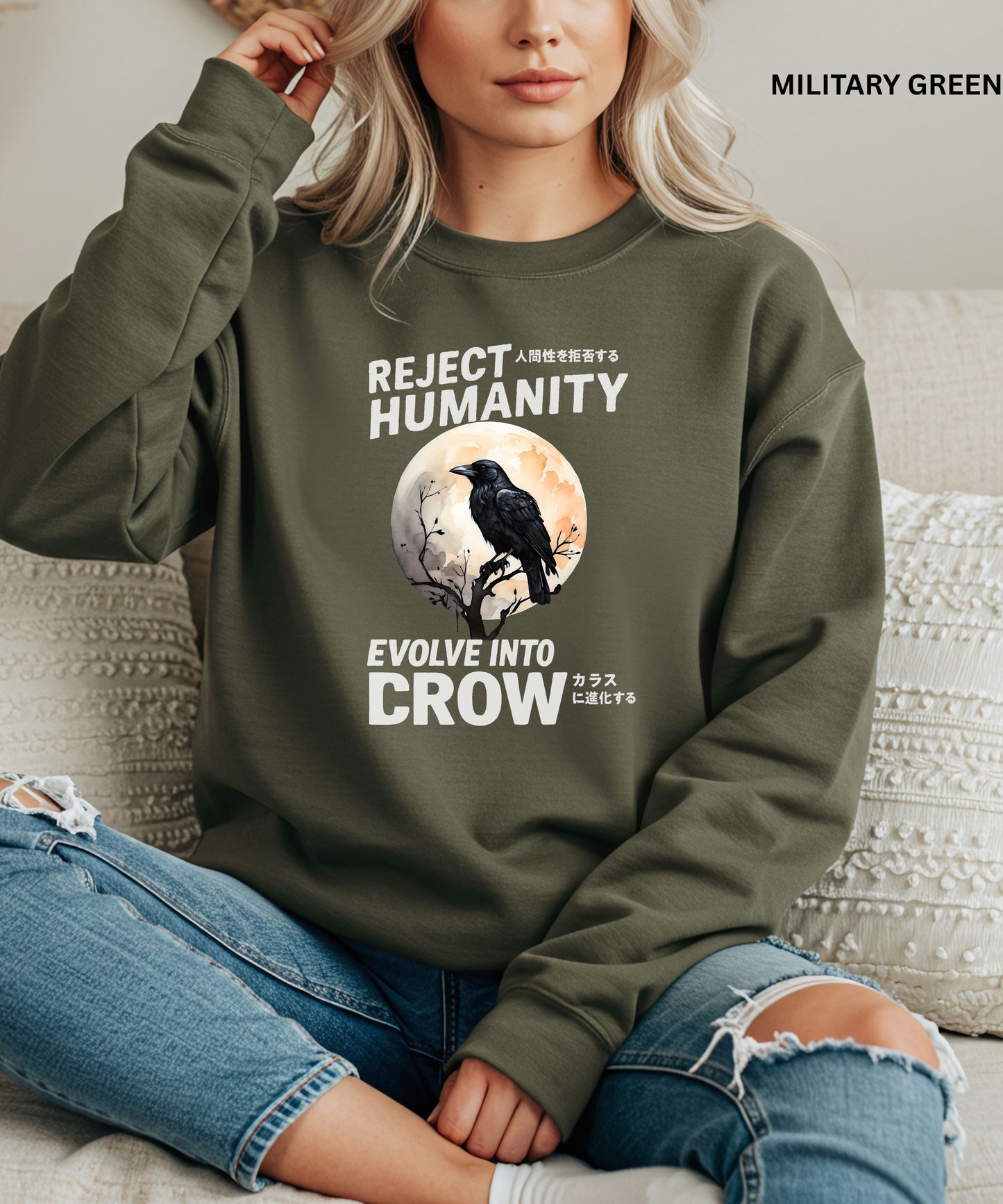 Person wearing a military green sweatshirt with a graphic design that says "reject humanity evolve into crow" sitting on a couch.