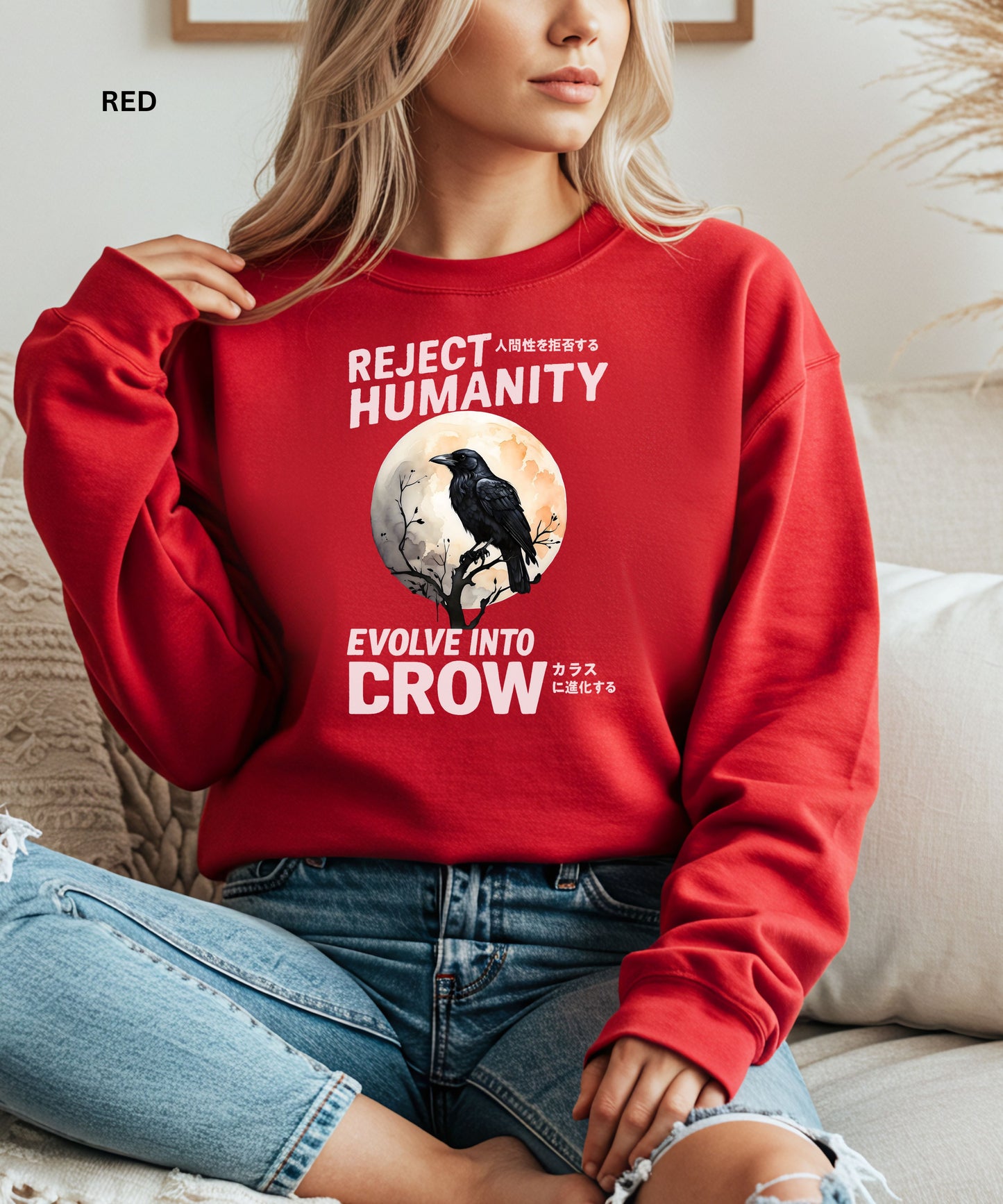 Person wearing a red sweatshirt with a graphic design that says "reject humanity evolve into crow" sitting on a couch.