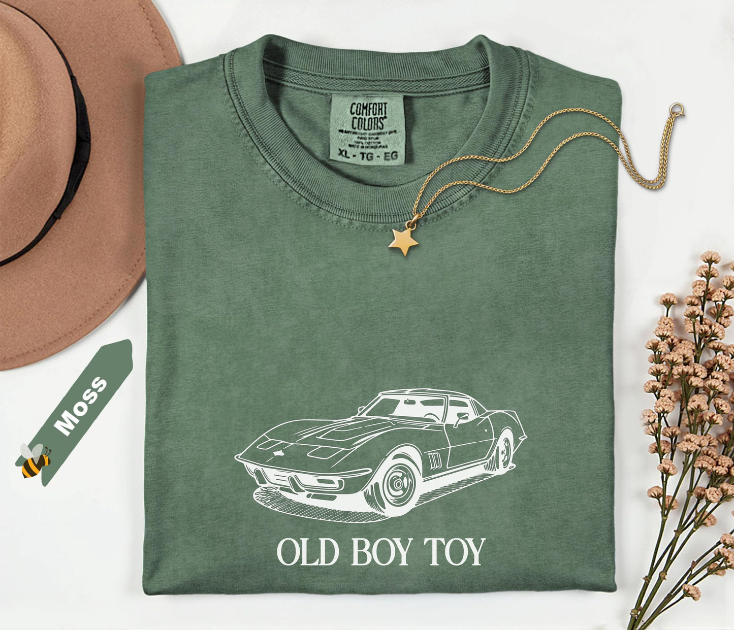 Green t-shirt with car graphic and text on a white background