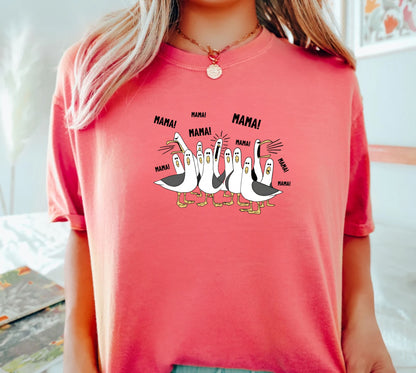 watermelon t-shirt with cartoon penguins screaming "Mama"  design and text worn by a person.