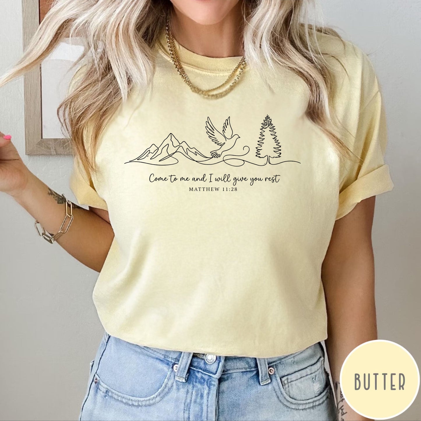  a butter t-shirt with nature-themed design and text that says "come to me and i will give you rest matthew 11:28" 